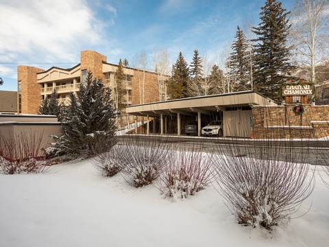 Chateau Chamonix offers a mountain retreat with convenient access via gondola, surrounded by natural winter beauty and conifer-lined grounds.