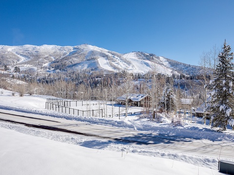 A snow-covered mountain landscape with ski slopes visible across pristine winter terrain. The property is located near picturesque winter scenery and ski areas.