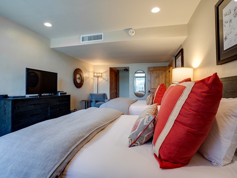 Sink into your plush bed with vibrant red pillows and feel the day's adventures melt away. Your cozy bedroom features a flat-screen TV and climate-controlled comfort for restful nights.