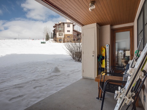 A ski-in, ski-out balcony with direct slope access and convenient gear storage. The property is nestled at the base of snowy slopes, offering immediate access to winter adventure right from your door.