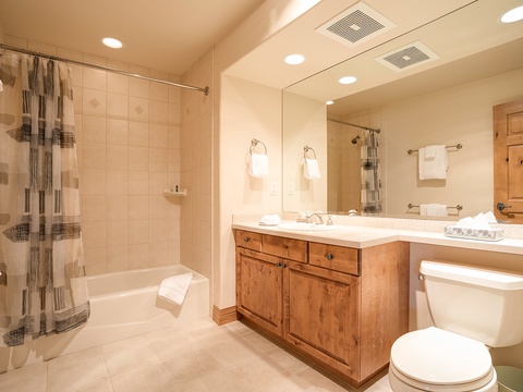 Unwind in your private bathroom featuring a soaking tub, fresh towels, and a spacious vanity—everything you need to refresh after a day exploring the mountains.