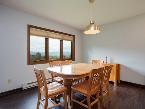 Gather around this inviting table and enjoy meals with stunning mountain views as your backdrop. The bright, airy space creates the perfect setting for memorable conversations.
