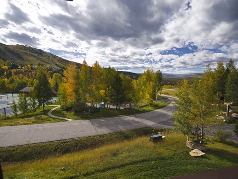 Scenic autumn landscape surrounds the property with golden aspens, mountain vistas, and peaceful roads winding through a tranquil mountain setting.