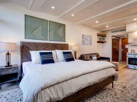 Your open-concept studio awaits with a plush king bed, cozy seating area, and full kitchen—perfectly blending comfort and convenience for your getaway.