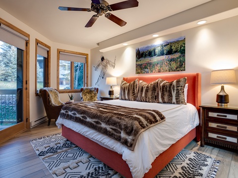 Step into your mountain retreat where crisp white linens and plush faux-fur bedding invite restful nights. Natural light streams through large windows as the ceiling fan keeps you comfortable year-round.