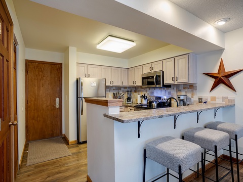Your fully equipped kitchen features stainless steel appliances, granite countertops, and a breakfast bar—perfect for cooking meals and sharing conversation over morning coffee.