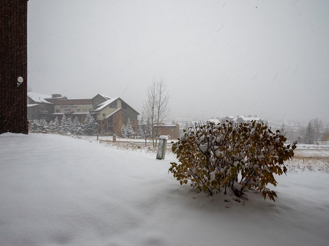 Snow-covered property nestled in a serene winter neighborhood with misty mountain-town charm creating a tranquil alpine escape.