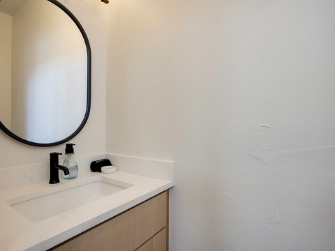 Modern simplicity meets comfort in your private bathroom, featuring clean lines, a stylish mirror, and everything you need to refresh after a day of adventure.