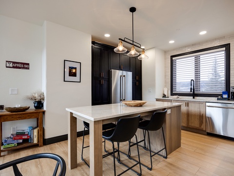 Gather around your stylish kitchen island for morning coffee or casual meals. Modern appliances and thoughtful design create a space where cooking feels effortless and relaxing.