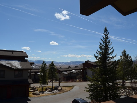Mountain resort community with scenic views, towering evergreens, and paved pathways winding through a peaceful alpine neighborhood.