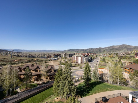 Expansive mountain resort community framed by rolling hills and clear blue skies, offering a scenic backdrop for your getaway.