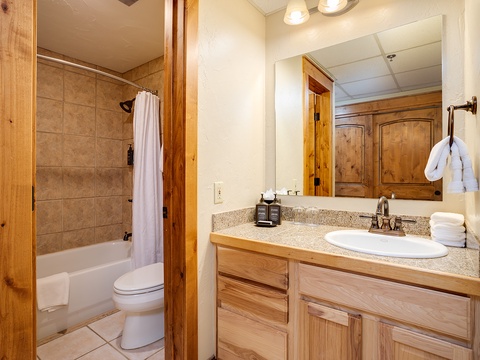 Refresh in your private bathroom featuring granite counters, plush towels, and a soothing tub-shower combo—perfect after a day exploring the mountains.