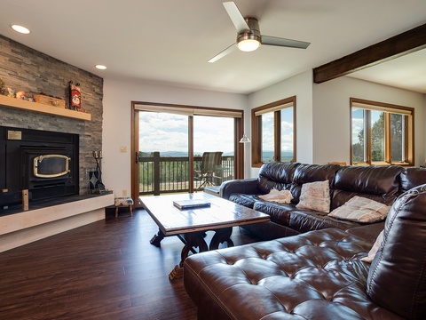 Sink into plush leather sofas where you can savor sweeping mountain views, the warmth of your fireplace, and cool breezes from your ceiling fan.