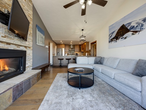 Sink into plush sofas by the glowing fireplace, where vaulted ceilings and mountain artwork set the scene for cozy evenings after your day on the slopes.