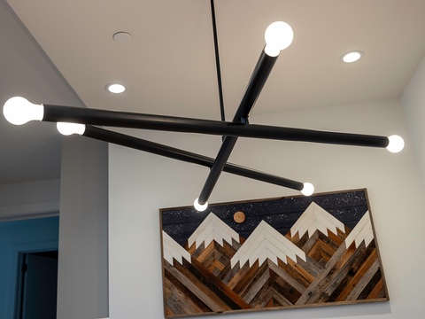 Modern lighting and artistic touches set a stylish, welcoming tone in your entryway, blending clean lines with creative design.