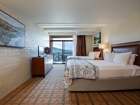 Wake to mountain views from your comfortable bed, where crisp linens and warm textures welcome you after adventure-filled days. Your private balcony brings the scenery right to your room.