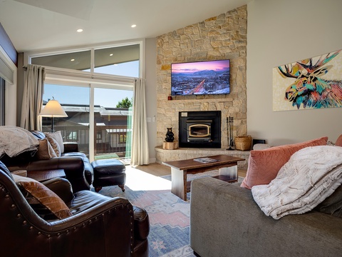 Curl up in your inviting living space with a crackling fireplace, mountain views on the TV, and cozy furnishings perfect for unwinding after a day of adventure.