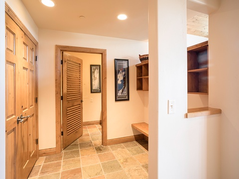 Warm wood tones and built-in storage create a welcoming entryway where you can settle in and feel at home the moment you arrive.