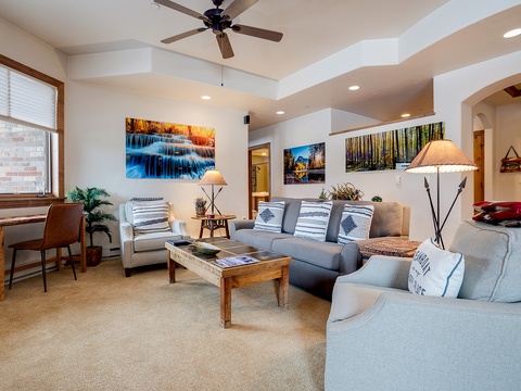 Settle into your spacious living room with plush seating, nature-inspired artwork, and soft lighting creating a welcoming retreat after your mountain adventures.