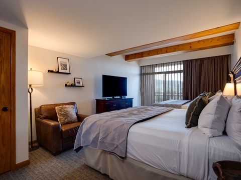 Sink into plush bedding and unwind in your serene bedroom, where warm wood accents and soft lighting create the perfect retreat after a day of adventure.