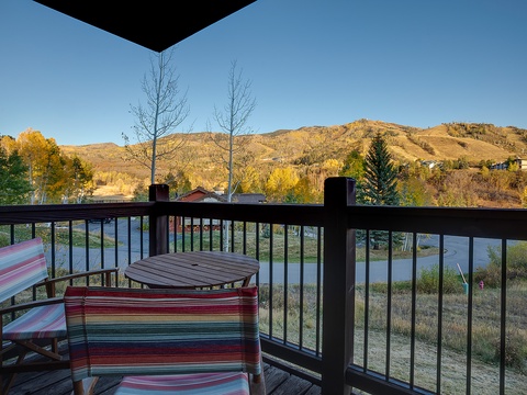 Peaceful mountain views and autumn colors frame this inviting deck space, perfect for unwinding with morning coffee or evening relaxation.