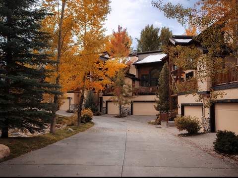 A mountain retreat nestled among brilliant autumn foliage, with convenient garage parking and surrounded by vibrant fall colors in a peaceful natural setting.