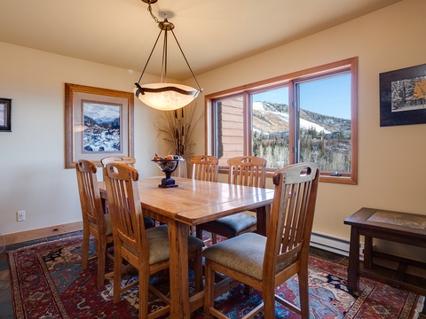 Gather around the handcrafted dining table for memorable meals with breathtaking mountain views framing every conversation. The warm, inviting space seats your group comfortably.