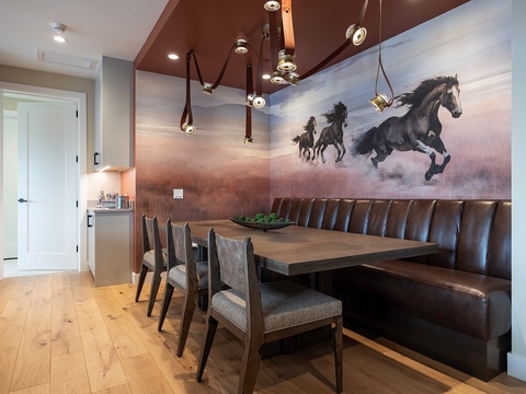 Gather around this stunning dining area where rustic elegance meets modern design. Rich leather banquette seating, unique pendant lighting, and a generous table create the perfect setting for your meals and conversations.