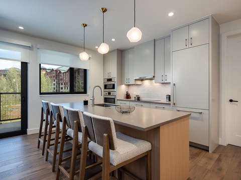Your spacious modern kitchen features a large island with seating, sleek cabinetry, and bright pendant lighting—perfect for cooking and gathering with loved ones.