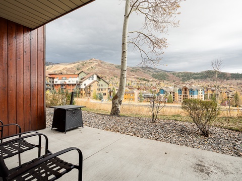 Private patio offering sweeping mountain and neighborhood views, with comfortable seating to enjoy the natural landscape and surrounding area year-round.