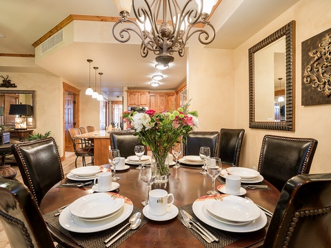 Gather around this elegant dining table for memorable meals together. The space features a striking chandelier, rich leather seating for eight, and beautiful décor that sets the scene for your vacation feasts.