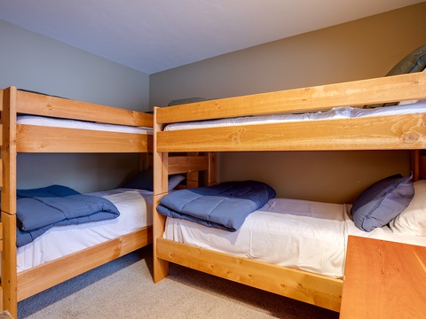 Your cozy bunk room features sturdy wooden beds with soft linens, perfect for groups or families seeking restful nights together.