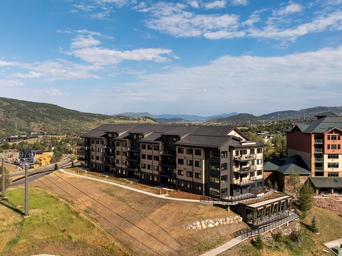 Mountain resort property nestled in a scenic valley, surrounded by rolling hills and dramatic peaks. The multi-building complex offers easy access to natural beauty and outdoor adventure.