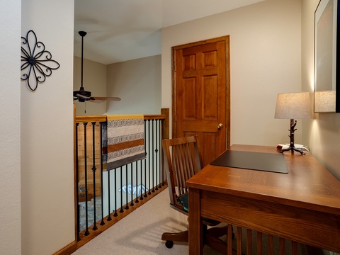 Your desk overlooks the first floor, offering a bright workspace with warm wood finishes and thoughtful décor that makes working or planning your day feel effortless and inspiring.
