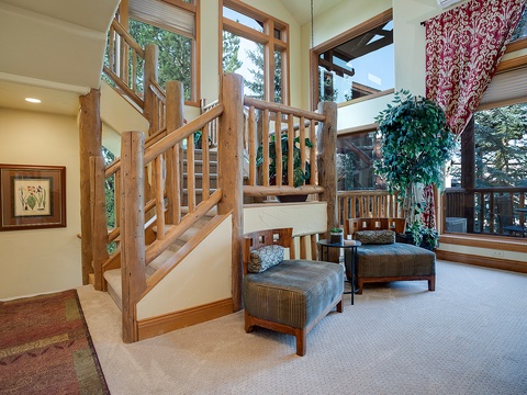 Settle into your private living area where soaring windows, cozy seating, and warm wood details create the perfect mountain getaway. Your own peaceful retreat awaits.