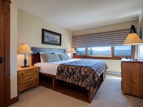 Wake up to breathtaking mountain vistas from your cozy bedroom, where warm wood furnishings and soft lighting create the perfect retreat after a day of adventure.