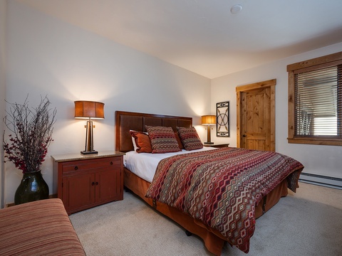 Sink into crisp linens and soft lighting in your serene bedroom retreat. Warm wood tones and thoughtful décor create a peaceful haven for restful nights.