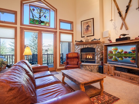Sink into plush leather seating as you warm up by the stone fireplace, enjoy your favorite shows, and take in mountain views through soaring windows that fill the room with natural light.