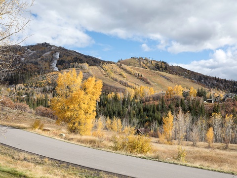 Scenic mountain landscape with autumn foliage and ski slopes, showcasing the property's picturesque neighborhood and natural surroundings during fall season.