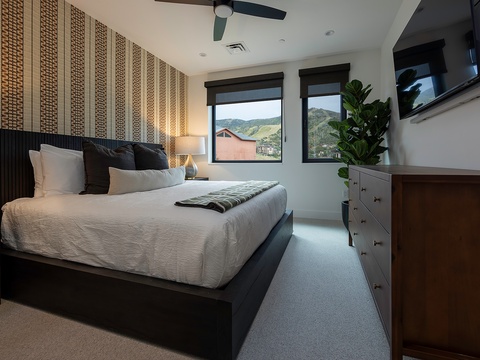 Wake up to mountain vistas framed by your bedroom windows, where crisp linens and modern design meet the perfect alpine retreat for your next adventure.