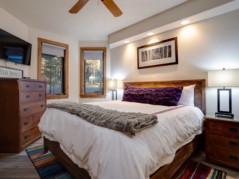 Slip into your cozy retreat with plush textures, warm wood accents, and woodland views framing your stay. Unwind with modern comforts and peaceful mountain charm all around you.