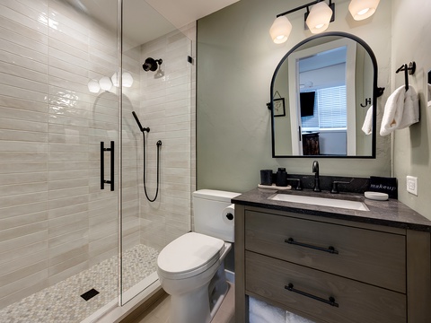 Step into your spa-like bathroom where gleaming white subway tiles and modern black fixtures create an elegant space for unwinding after a day of adventure.