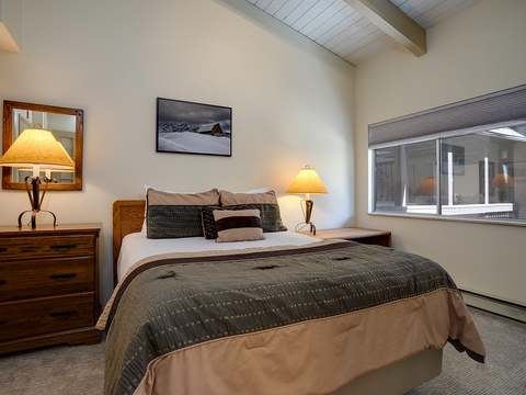 Sink into your plush bed as warm lamplight glows, creating a peaceful retreat where you can unwind under exposed beam ceilings after a day exploring the mountains.