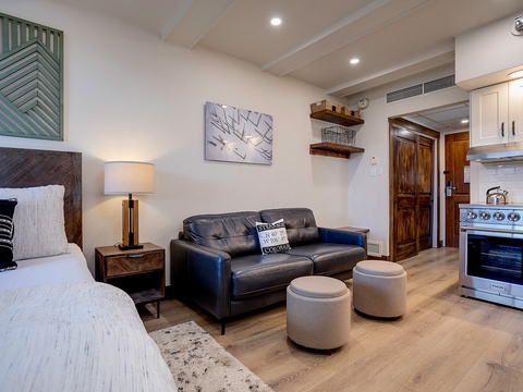 Unwind in your open-plan studio with plush seating, a cozy bed, and a fully equipped kitchen ready for your culinary adventures. Modern comforts meet warm style.