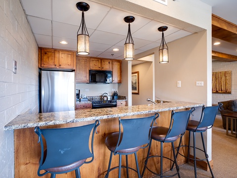 Your open kitchen flows into a welcoming dining space where you can gather for meals or casual conversation. Granite counters and stainless appliances give you everything you need to prepare home-cooked favorites.