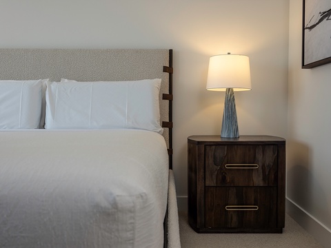 Slip into crisp linens and unwind beneath the warm glow of your bedside lamp. The thoughtfully curated décor and plush furnishings create a peaceful sanctuary where your restful retreat begins.