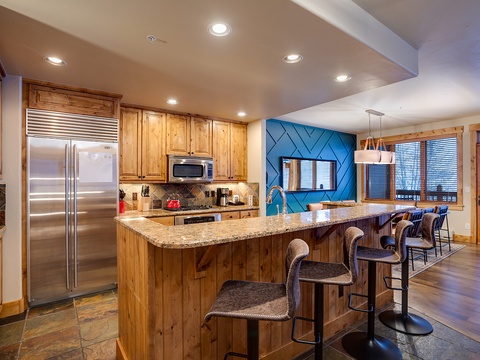 Gather around the spacious granite island with seating for five, where you can cook, dine, and share stories in this fully equipped kitchen with stainless appliances.