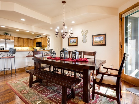 Gather around the spacious dining table, perfect for family meals and game nights, or unwind at the kitchen bar as warm lighting and mountain-inspired decor create a welcoming retreat for your stay.