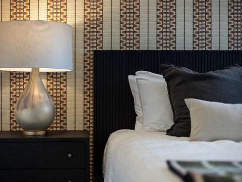 Slip into crisp, fresh linens piled with plush pillows after a long day of exploring. Your modern bedroom blends warm textures and soft lighting for the perfect unwind.