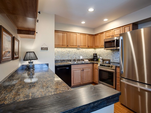 Your fully equipped kitchen features stunning granite countertops, stainless steel appliances, and ample cabinet space—perfect for preparing meals and gathering with loved ones during your stay.